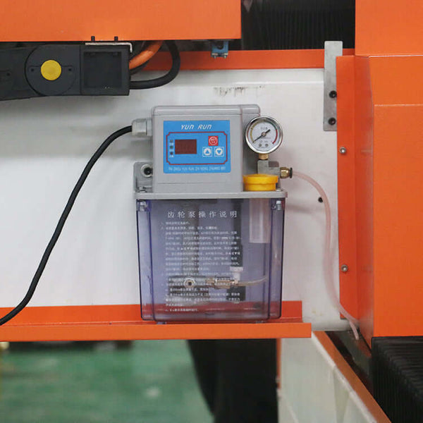 Close-up of lubrication system on high-precision CNC router for foam and 3D engraving, featuring pressure gauge and control panel.