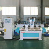 Precision multi-head 4-axis CNC router for 3D wood carving and mass production, featuring a durable welded steel table.