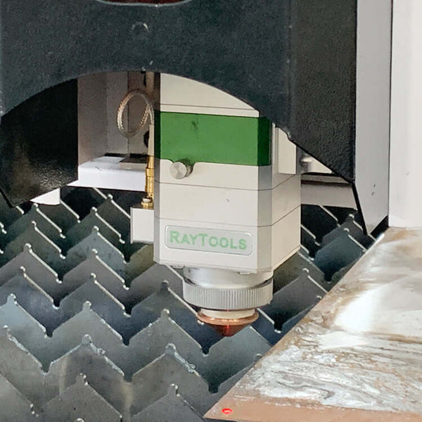 Fiber laser cutting machine head in action on metal surface, model F3015, ideal for high-precision industrial applications.