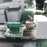 Customized small size 4-axis ATC CNC router with rotary axis and swing arm for precision machining on a workshop table.