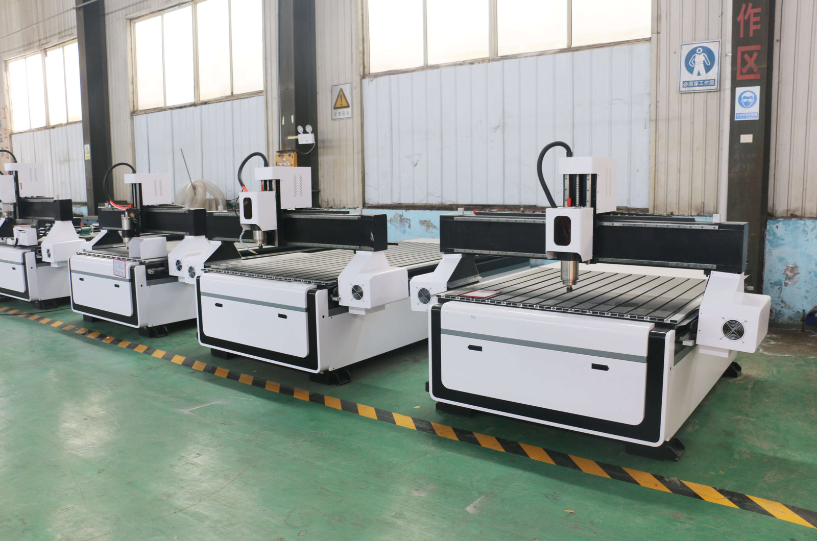 Row of CNC wood engraving machines in a workshop, essential for woodworking and furniture manufacturing efficiency.