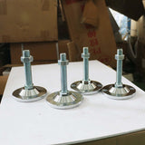 Adjustable metal frame feet with screws, ideal for stabilizing furniture or machinery, shown against a workshop backdrop.