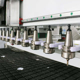Close-up of CNC machine tool holders in a row, highlighting precision engineering and advanced manufacturing technology.