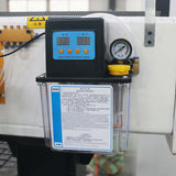 Oil lubrication system with digital control panel installed on machinery, featuring pressure gauge and instruction label.