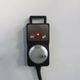 Handheld CNC controller with two dials and LED indicator, used for precision adjustments in CNC machinery operations.