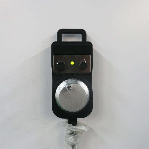 Handheld control pendant for CNC router with dial and adjustment knobs, used for precise machine control.