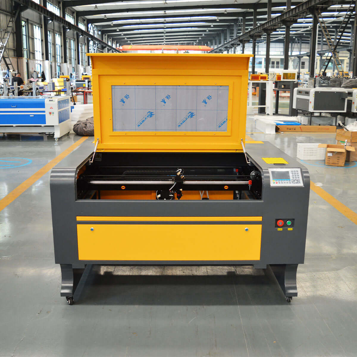 CO2 laser engraving machine for cutting wood and acrylic in a factory setting, featuring high precision and versatile material use.