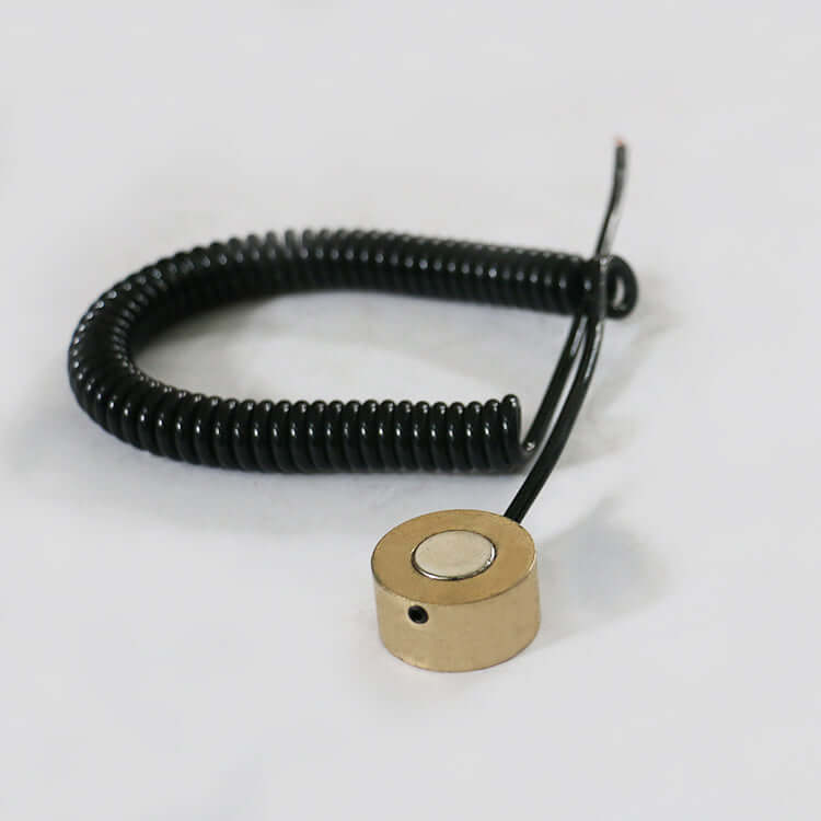 Precision tool sensor with coiled black cable for accurate measurement applications.
