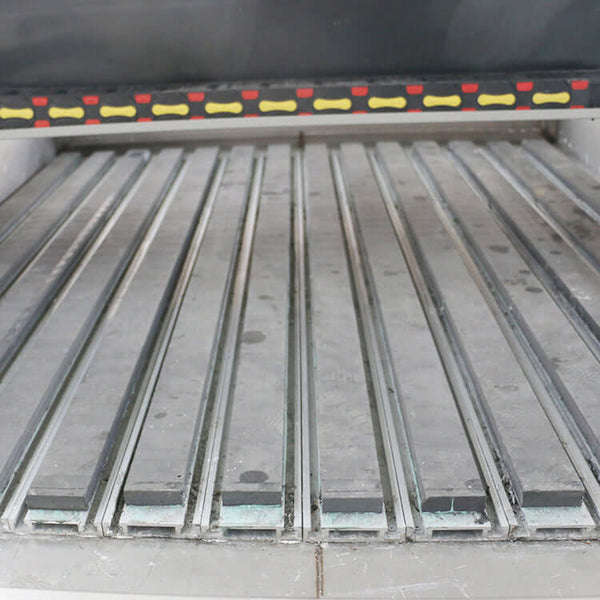 Close-up view of customized metal CNC router bed with precision grooves for accurate machining and cutting operations