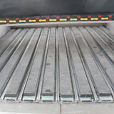 Close-up view of customized metal CNC router bed with precision grooves for accurate machining and cutting operations