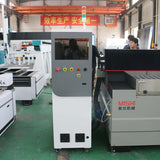 Industrial CNC router with control panel in a factory setting