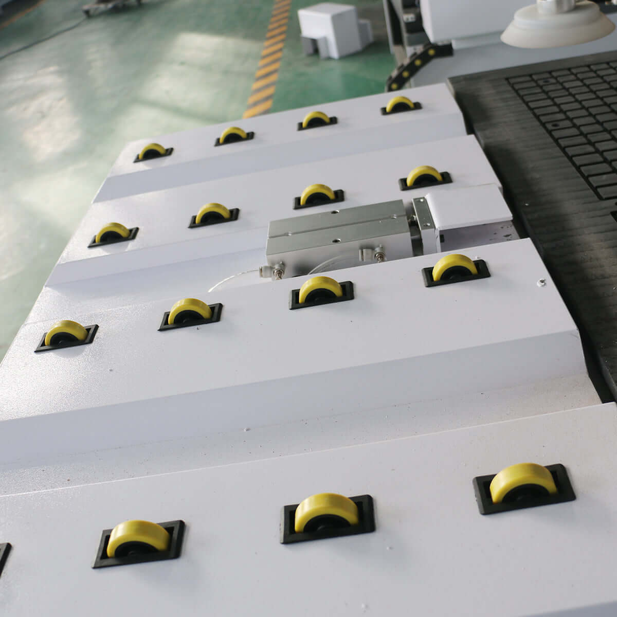 Auto-loading ATC CNC router with yellow wheels for efficient furniture production. Ideal for high-speed cabinet making.