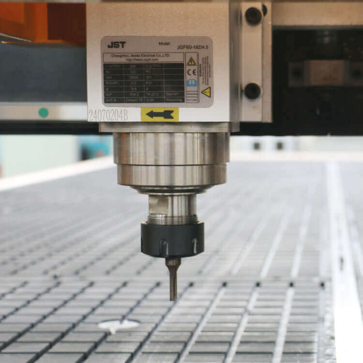 Close-up of a CNC machine spindle over a grid surface, used for precise cutting and engraving in industrial manufacturing.