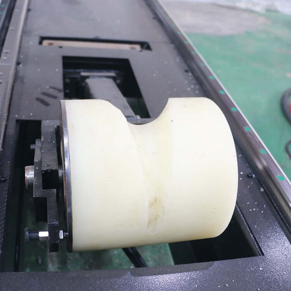 Detail of a high-precision fiber laser cutting machine component for metal sheets and pipes.