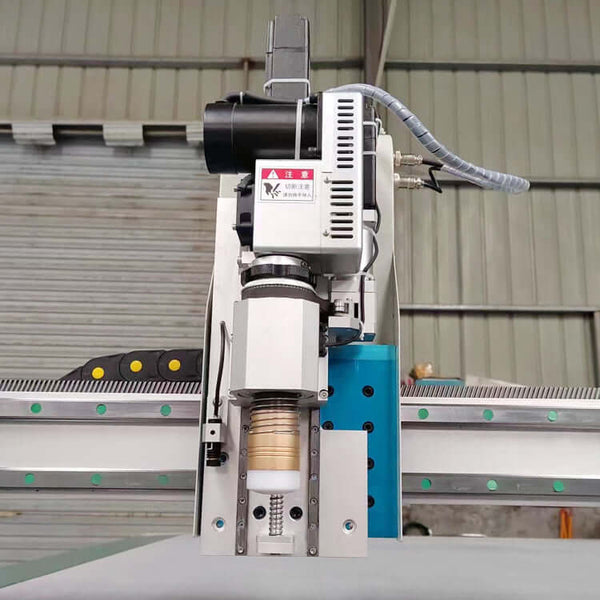 High-speed oscillating knife cutting machine for leather, rubber, and textiles in industrial setting.