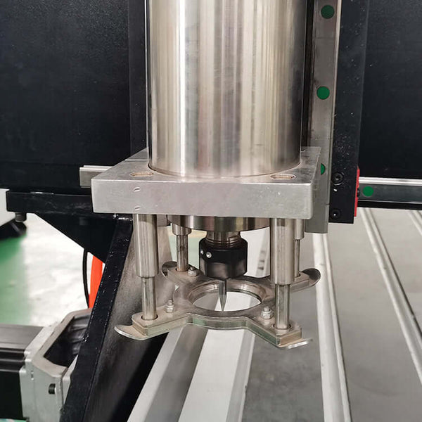 Close-up of industrial platen press component with metallic finish in a factory setting