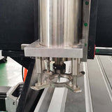 Close-up of industrial platen press component with metallic finish in a factory setting