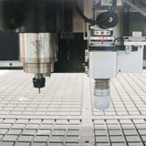 Oscillating knife cutting machine on a textured surface, highlighting precision cutting tools and advanced industrial machinery.