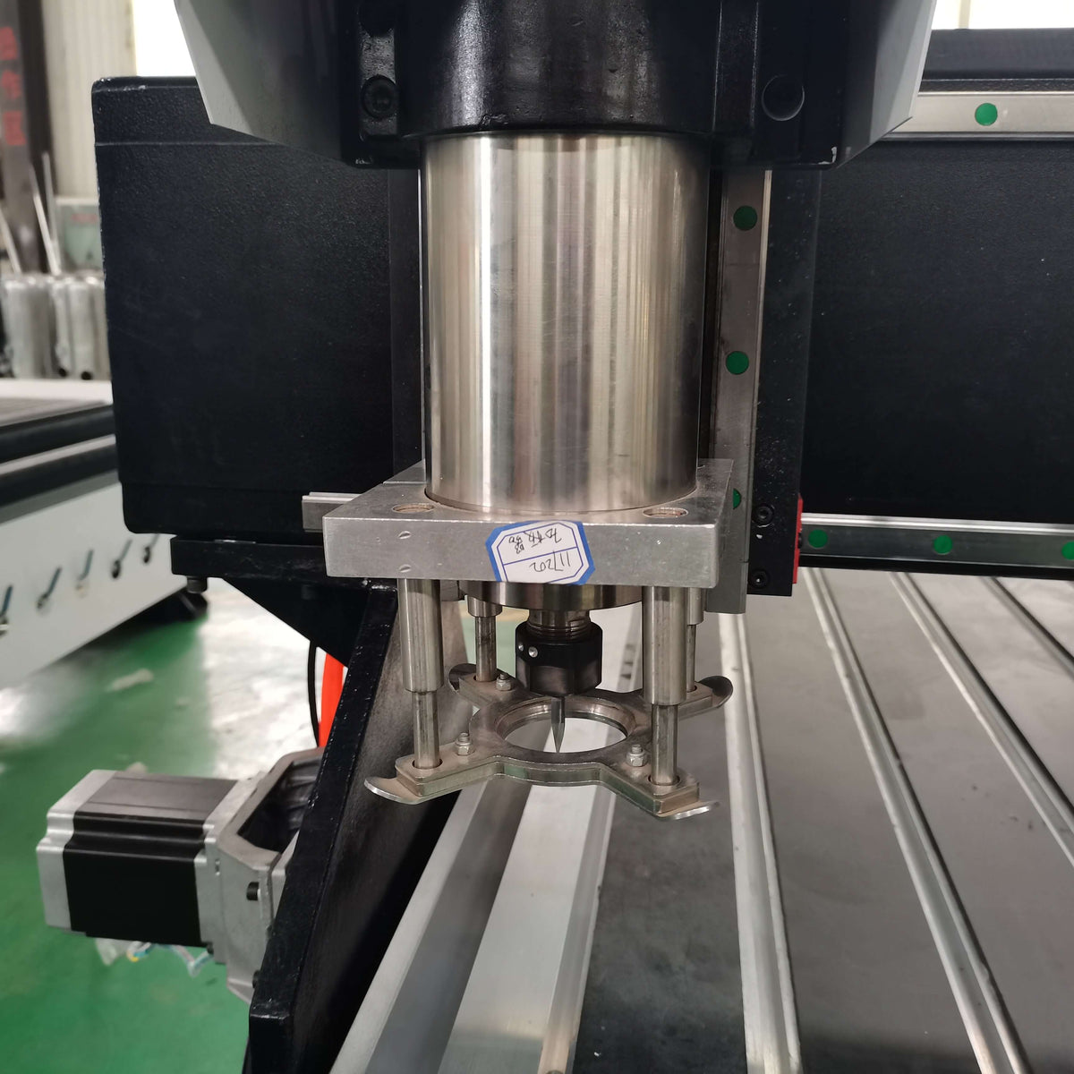 Industrial platen press machine in a factory setting, showcasing the metal components and mechanical parts.