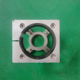 Metal platen press component on green background for industrial use.
