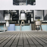 Close-up view of a precision oscillating knife cutting machine on a factory floor, highlighting the tool's advanced technology.