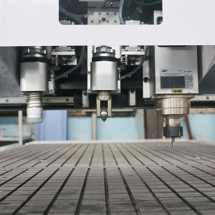 Close-up view of a precision oscillating knife cutting machine on a factory floor, highlighting the tool's advanced technology.