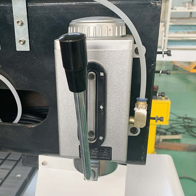 Close-up of oil lubrication system for industrial machinery with metal housing and attached lever.