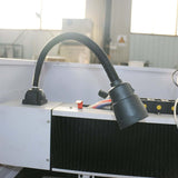 Close-up of water cooling spindle on mini CNC router for precision metal milling in factory setting