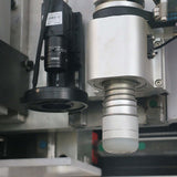 Close-up of Multifunction ATC CNC Router with oscillating knife and CCD camera for precision cutting and engraving in industrial applications.