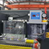 Close-up of ATC CNC Router with CCD Camera and Pressure Roller components, highlighting industrial machinery features in a workshop.