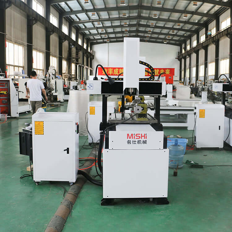 4 Axis Mini CNC Router in industrial setting, used for 2D and 3D carving on metals like stainless steel and aluminum.