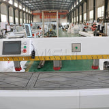 Precision CNC side hole drilling machine for furniture production in a factory setting, featuring advanced screen controls.