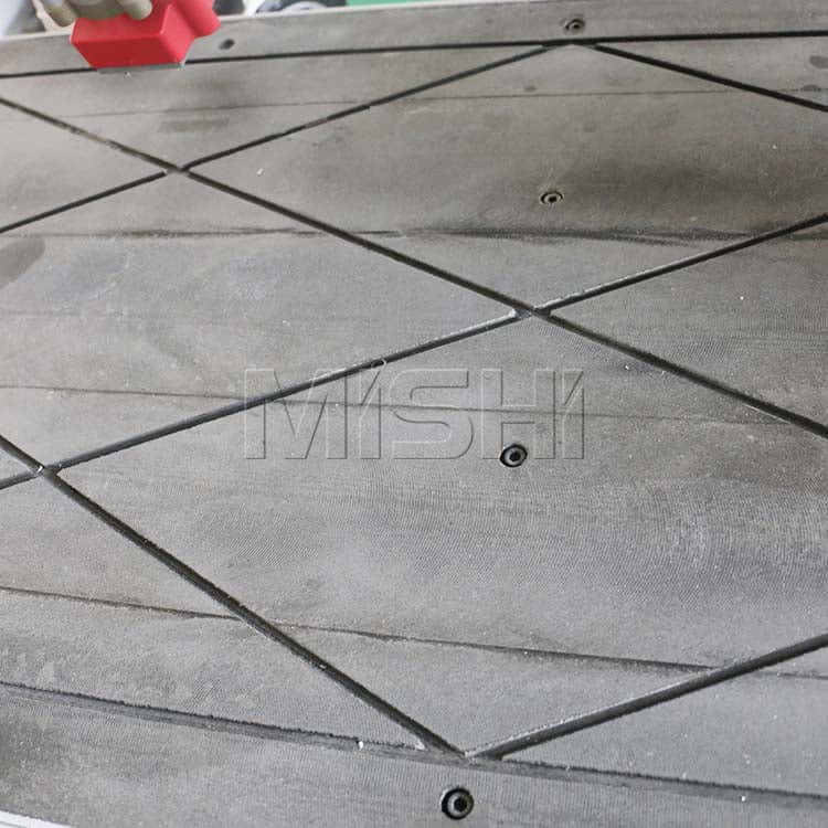 Close-up of CNC side hole drilling machine table with precision grooves for furniture production