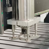 Industrial platen press machine showcasing metal components on a precision table in a manufacturing setting.