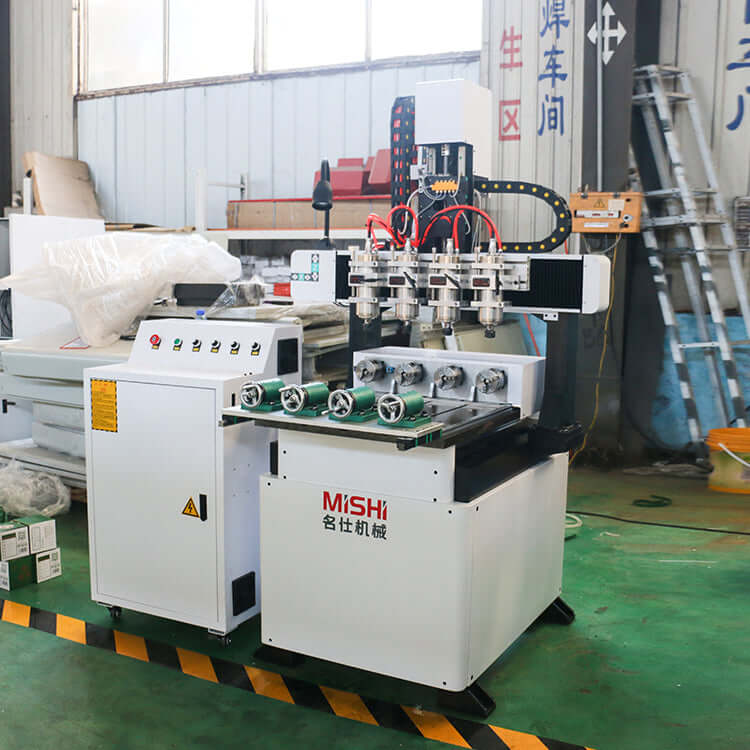 Precision multi head 4-axis mini CNC router for 3D wood carving and metal engraving in a workshop setting.